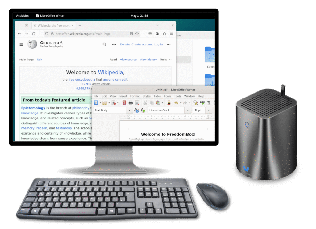 Image showing FreedomBox machine with a monitor, a keyboard, and a mouse. The monitor shows GNOME desktop interface with Firefox and LibreOffice apps.